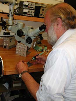 Al Alden soldering at a microscope