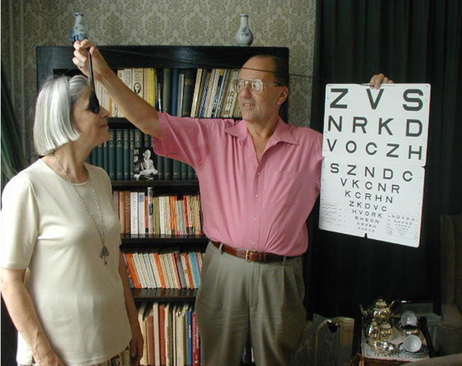Dr. Colenbrander demonstrating his 1-Meter letter chart on his sister Jetteke.