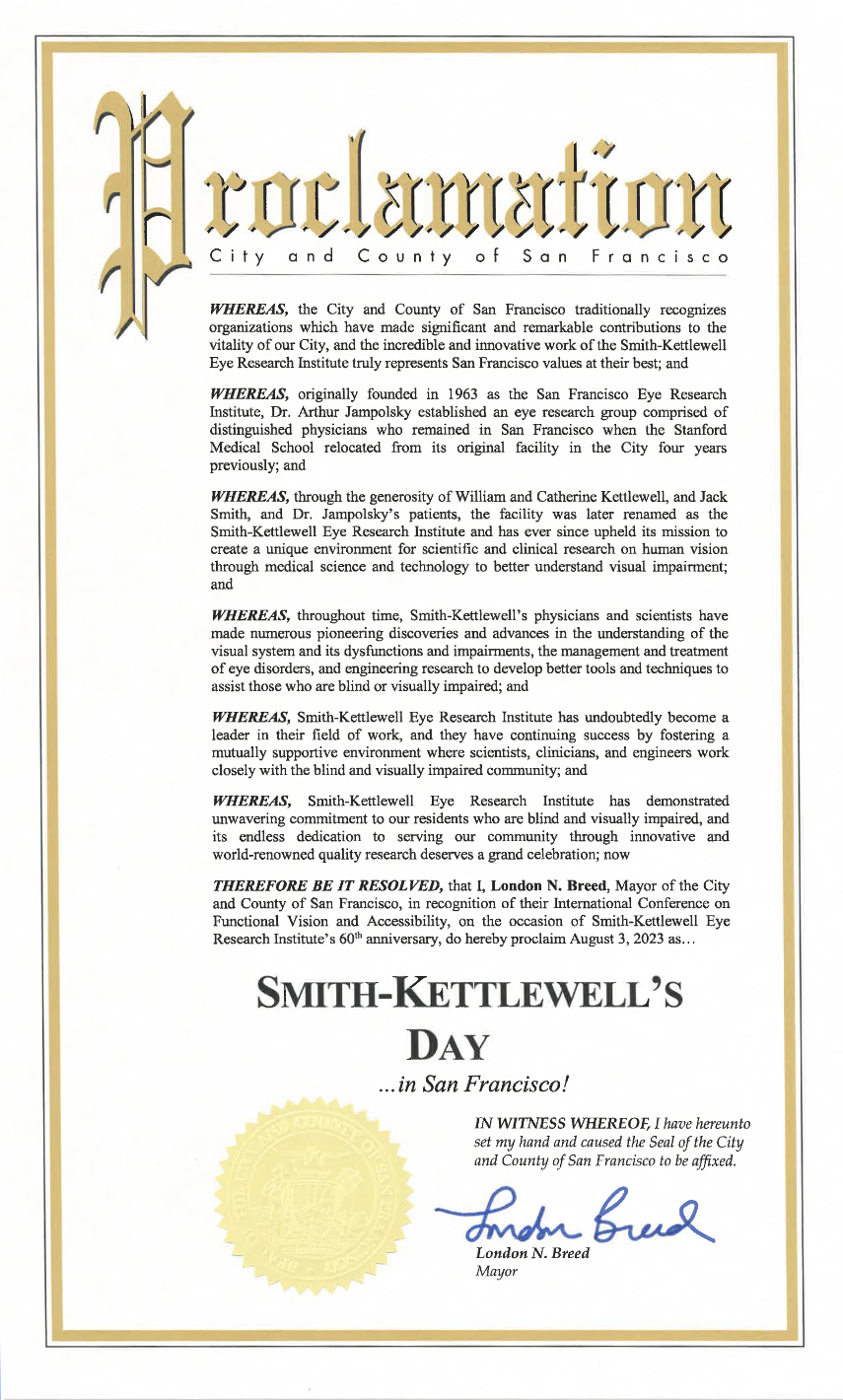 Scanned ceremonial document with a gold trimmed border and florid title reading "Proclamation, City and County of San Francisco." Several recital paragraphs begin with "Whereas" and cite Smith-Kettlewell's 1963 founding, its early support from donors and patients, its ongoing pioneering research, and a demonstrated commitment to the community of blind and visually impaired persons. The document concludes with Mayor London Breed's proclamation of August 3, 2023 as Smith-Kettlewell's Day in San Francisco.