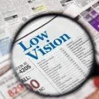 words "low vision" seen through a magnifying glass