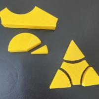 Two printed yellow triangles. The angles are removable and can be placed in a 180 deg half circle.