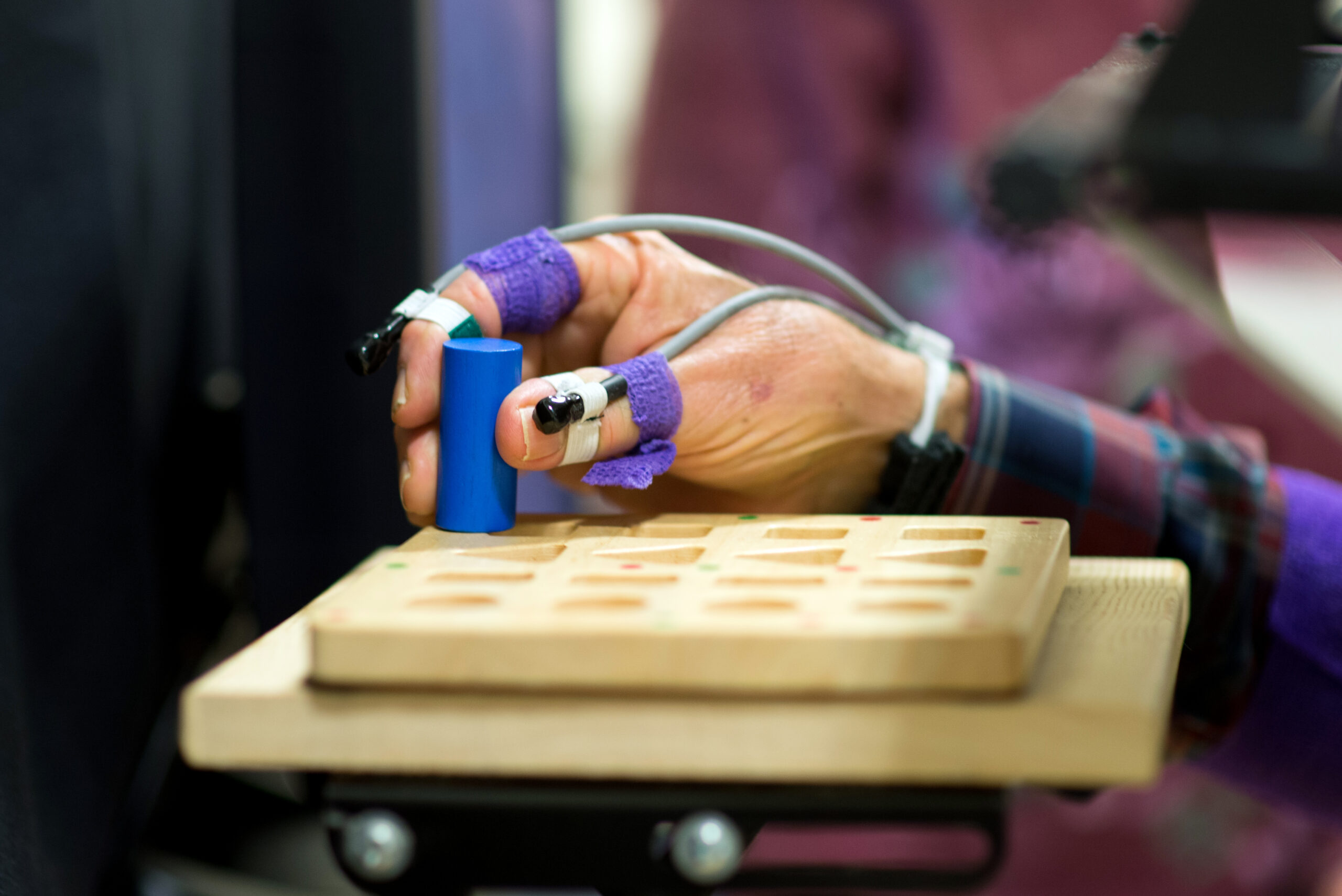 Placing a peg in a peg board while hand and finger position is being tracked.