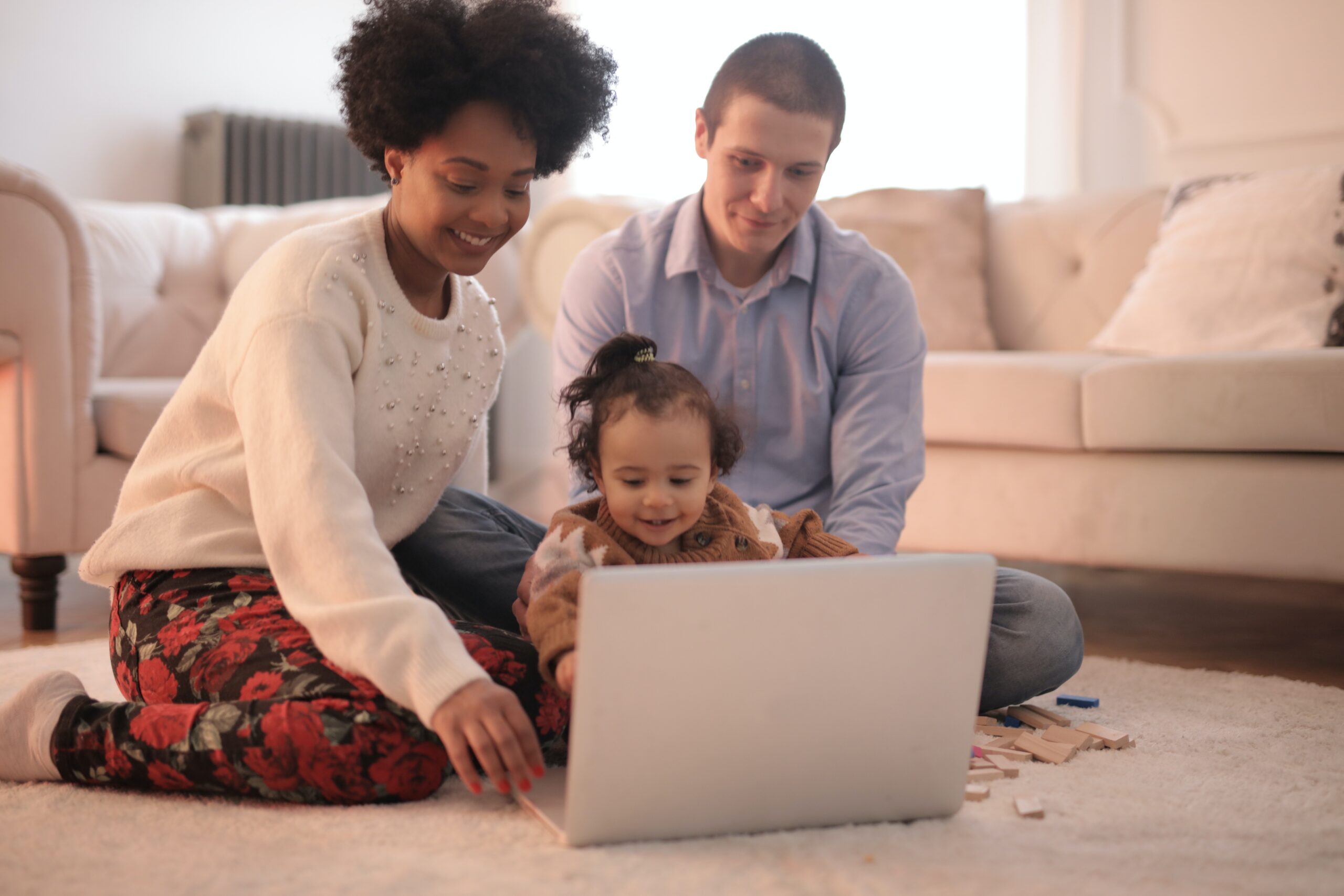 Man, woman, and child looking at a laptop