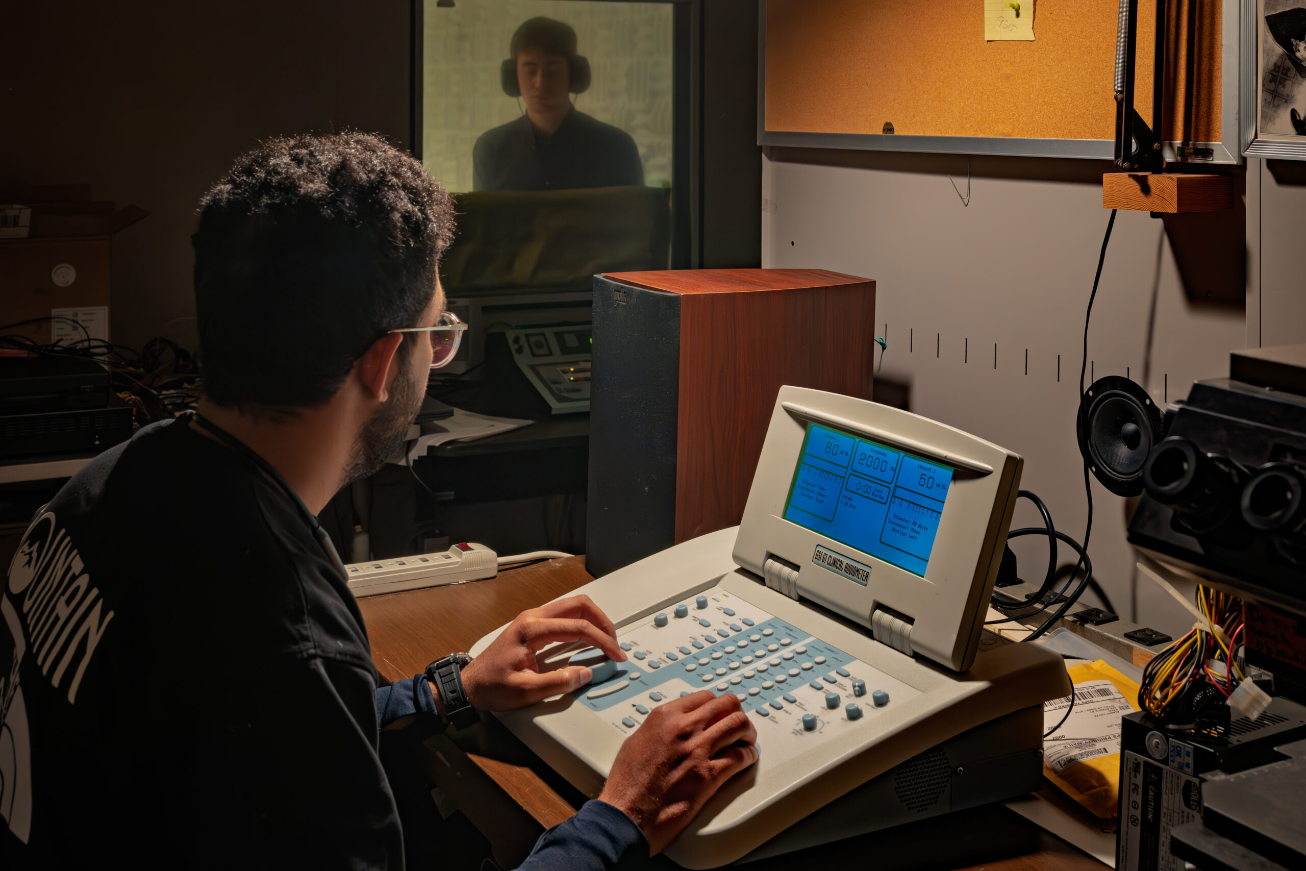 Praveen Prakash, researcher and audiologist at Smith-Kettlewell Eye Research Institute using an Audiometer to check for hearing loss indicators.
